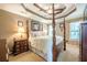 Spacious main bedroom featuring a tray ceiling, a four-poster bed, and soft natural light at 435 Flowering Trl, Grayson, GA 30017