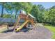 Neighborhood playground with a wooden play structure with slide, ladders and climbing nets for hours of fun at 435 Flowering Trl, Grayson, GA 30017
