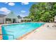 Community pool with brick trim, white pool house and shaded gazebo perfect for neighborhood recreation and relaxation at 435 Flowering Trl, Grayson, GA 30017