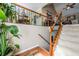 The staircase has wood and iron accents, and is flooded with light from nearby windows at 435 Flowering Trl, Grayson, GA 30017
