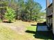 View of the backyard with patio and treeline near house at 533 Mount Gerizim Se Rd, Mableton, GA 30126
