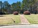Outdoor basketball court with black chain link fence, brick pathway, and surrounding trees at 533 Mount Gerizim Se Rd, Mableton, GA 30126