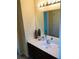 Bathroom features a white sink and vanity, large mirror, and neutral wall paint at 533 Mount Gerizim Se Rd, Mableton, GA 30126