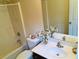 Bathroom features a white sink, mirror, toilet, tub and shower with decorative touches and good lighting at 533 Mount Gerizim Se Rd, Mableton, GA 30126