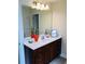 Bright bathroom with large mirror over a vanity with dark wood cabinets at 533 Mount Gerizim Se Rd, Mableton, GA 30126