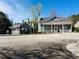 Well-maintained community clubhouse with a covered porch, landscaping, and parking at 533 Mount Gerizim Se Rd, Mableton, GA 30126
