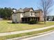 Beautiful home with a covered front porch, lush green lawn, and mature trees at 533 Mount Gerizim Se Rd, Mableton, GA 30126