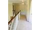 Upstairs hallway with neutral paint, carpet and wood railing at 533 Mount Gerizim Se Rd, Mableton, GA 30126