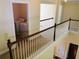 Hallway with laundry room, carpeted floors, and white banisters at 533 Mount Gerizim Se Rd, Mableton, GA 30126