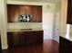 Kitchen features dark wood cabinets, sleek cooktop, and light countertops at 533 Mount Gerizim Se Rd, Mableton, GA 30126