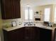 Kitchen featuring dark wood cabinets, a stainless steel sink and modern appliances, well lit by natural sunlight at 533 Mount Gerizim Se Rd, Mableton, GA 30126