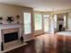 Open-concept living room boasting hardwood floors, a fireplace, and bright windows with a view of the surrounding landscape at 533 Mount Gerizim Se Rd, Mableton, GA 30126