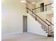 Bright living room features an open staircase, neutral carpet, and light walls at 533 Mount Gerizim Se Rd, Mableton, GA 30126