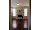 Living room featuring hardwood floors, a fireplace and mantle, neutral paint, and sunlit windows at 533 Mount Gerizim Se Rd, Mableton, GA 30126