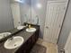 Bathroom features double sinks with stylish fixtures, a large mirror, and plenty of counter space at 5578 Swanson Rd, Ellenwood, GA 30294