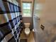 Bathroom featuring neutral walls, window with view, and toilet in a small space at 5578 Swanson Rd, Ellenwood, GA 30294