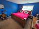 Vibrant bedroom featuring a bright pink bed and ample natural light from the window at 5578 Swanson Rd, Ellenwood, GA 30294