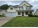 Charming two-story home with green lawn and attached two car garage at 5578 Swanson Rd, Ellenwood, GA 30294