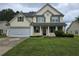 Charming two-story home with green lawn and attached two car garage at 5578 Swanson Rd, Ellenwood, GA 30294