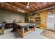 Basement workshop featuring ample workspace, storage shelves, and plenty of light at 6310 Stillwood Ln, Cumming, GA 30041