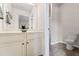 Bright bathroom features a large vanity with a white countertop and ample storage space at 6310 Stillwood Ln, Cumming, GA 30041
