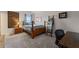 Comfortable bedroom featuring carpeted floors, a wooden bed frame, bedside table, and a decorative blanket ladder at 6310 Stillwood Ln, Cumming, GA 30041