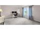 Spacious bedroom with a large window, desk area, and plush carpet flooring at 6310 Stillwood Ln, Cumming, GA 30041