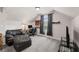 Bonus room featuring comfortable seating, carpeted floors, a vaulted ceiling, and a large window at 6310 Stillwood Ln, Cumming, GA 30041