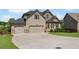Two-story home with three-car garage, manicured lawn, and brick accents at 6310 Stillwood Ln, Cumming, GA 30041