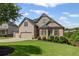 Beautiful two-story home with brick and beige siding, manicured lawn, and three-car garage at 6310 Stillwood Ln, Cumming, GA 30041