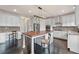 Spacious kitchen boasts custom cabinets, stainless appliances, eat-in island and desk area perfect for working at home at 6310 Stillwood Ln, Cumming, GA 30041