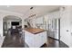 Eat-in kitchen with stainless appliances, center island, and view into the adjacent living area at 6310 Stillwood Ln, Cumming, GA 30041