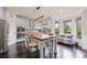 Bright eat-in kitchen features a large island, stainless appliances, and adjacent sitting area with backyard view at 6310 Stillwood Ln, Cumming, GA 30041