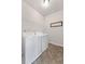 Bright laundry room features a full-size washer and dryer, overhead shelving, and durable flooring for easy cleanup at 6310 Stillwood Ln, Cumming, GA 30041