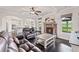 Bright living room featuring a stone fireplace, leather furniture, and hardwood floors at 6310 Stillwood Ln, Cumming, GA 30041