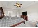 Spacious primary bedroom includes a tray ceiling, plush carpeting, generous closet space and great backyard views at 6310 Stillwood Ln, Cumming, GA 30041