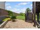 Relaxing brick patio with stairs to backyard featuring manicured stone and mulch flower beds at 6310 Stillwood Ln, Cumming, GA 30041
