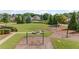 Community playground with swing set and fire pit at 6310 Stillwood Ln, Cumming, GA 30041