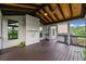 Charming covered porch with wood ceiling and flooring, ideal for relaxation and entertaining at 6310 Stillwood Ln, Cumming, GA 30041