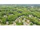 Overhead shot displays houses nestled amongst trees in a suburban community at 750 Highview Ct, Woodstock, GA 30189