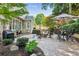 A lush backyard offers a stone patio with outdoor cooking area and fire pit at 750 Highview Ct, Woodstock, GA 30189