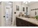 Well-lit bathroom featuring a dark wood vanity, granite countertop, and tiled floors at 750 Highview Ct, Woodstock, GA 30189