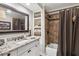 Updated bathroom with granite counters, a shower-tub combo and a framed mirror at 750 Highview Ct, Woodstock, GA 30189