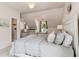 Comfortable bedroom with built-in bench seating, a decorative light fixture, and soft bedding at 750 Highview Ct, Woodstock, GA 30189