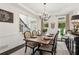 Elegant dining room featuring a chandelier, wainscoting, and a view of the foyer at 750 Highview Ct, Woodstock, GA 30189