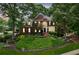 Charming two-story brick home with manicured front yard, lush landscaping, and inviting curb appeal at 750 Highview Ct, Woodstock, GA 30189