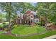 Charming two-story brick home with manicured front yard, lush landscaping, and inviting curb appeal at 750 Highview Ct, Woodstock, GA 30189