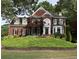 Stunning brick home with well-maintained landscaping, green lawn, and elegant architectural design at 750 Highview Ct, Woodstock, GA 30189