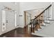 Bright foyer with hardwood floors, staircase, and a view into the formal dining area at 750 Highview Ct, Woodstock, GA 30189