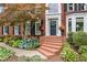 Elegant brick front entrance showcasing a classic door, decorative planters, and manicured landscaping at 750 Highview Ct, Woodstock, GA 30189